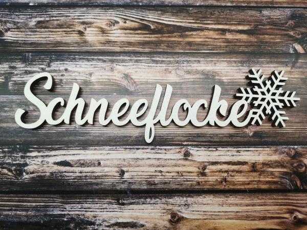 Schriftzug Schneeflocke aus Holz in weiß